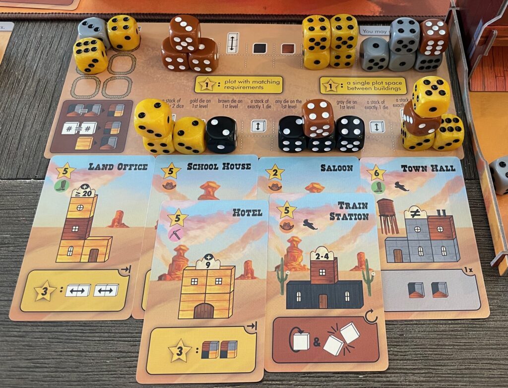 This is the game in progress. Use your dice to construct buildings in the Old West!